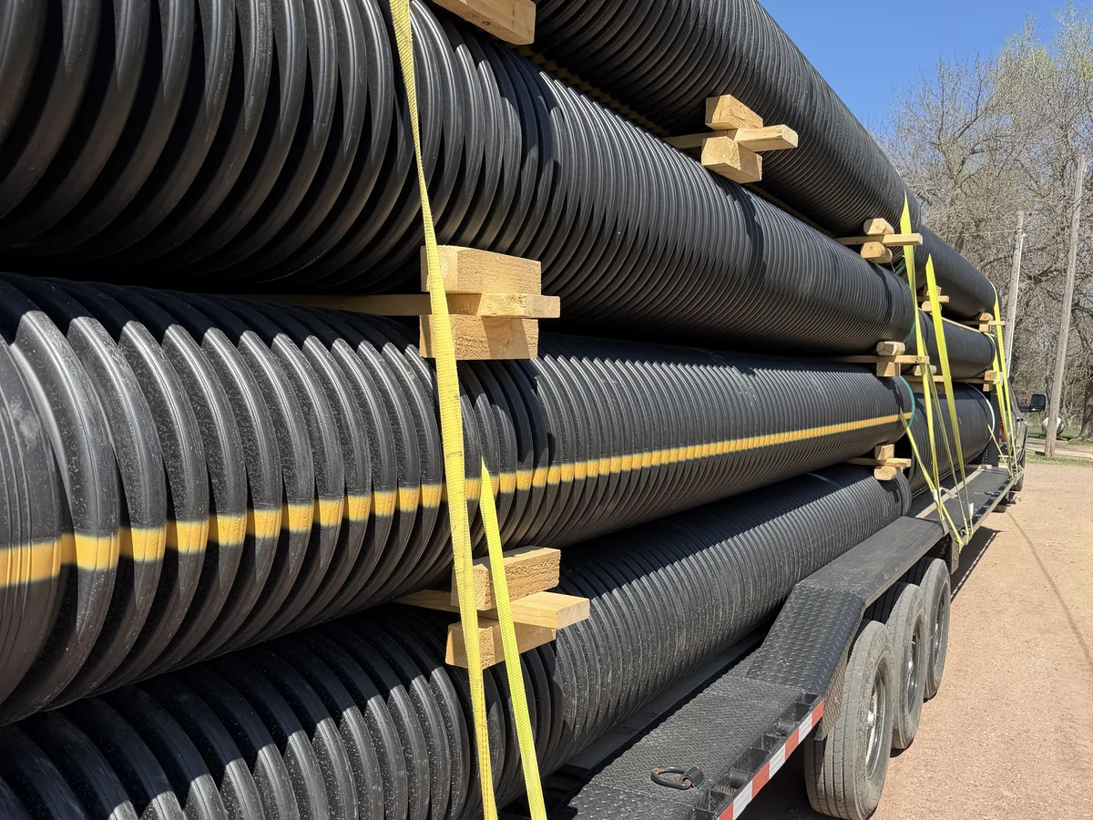 Full trailer load of HDPE culvert pipe, strapped and blocked for delivery across Colorado